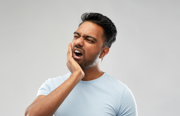 Man in pain holding his jaw