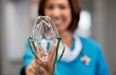 Dentist holding up oxygen mask