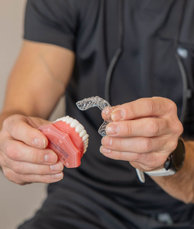 Staff member holding clear aligner at Pocock Family Dental in Twin Falls ID.