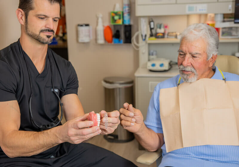 Staff member holding clear aligner at Pocock Family Dental in Twin Falls ID.