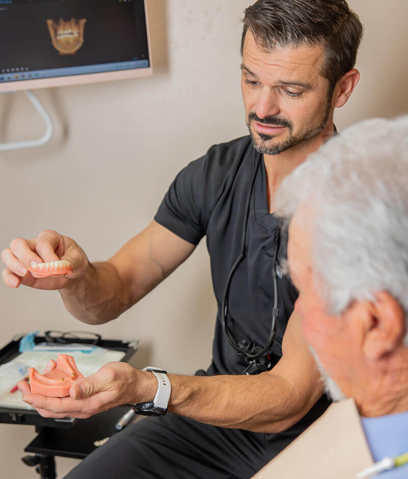 Dr Pocock holding dental implants at Pocock Family Dental in Twin Falls ID.